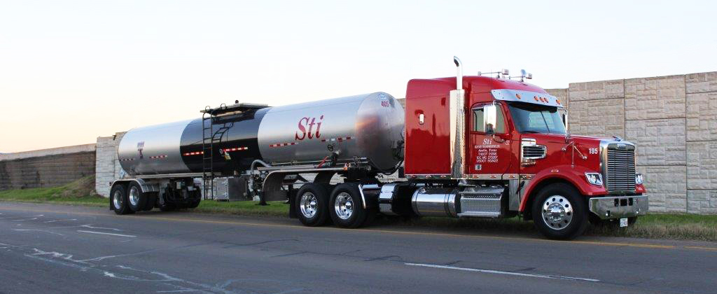 Red Skinner Transportation tractor parked on an open Texas highway